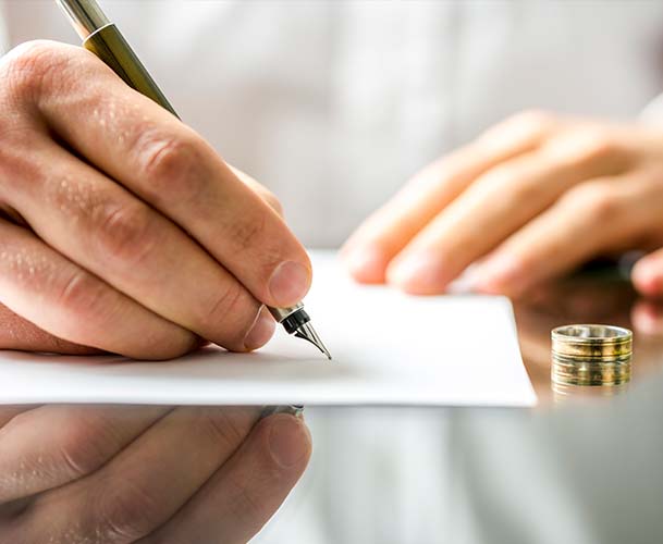 Woman signing divorce paperwork
